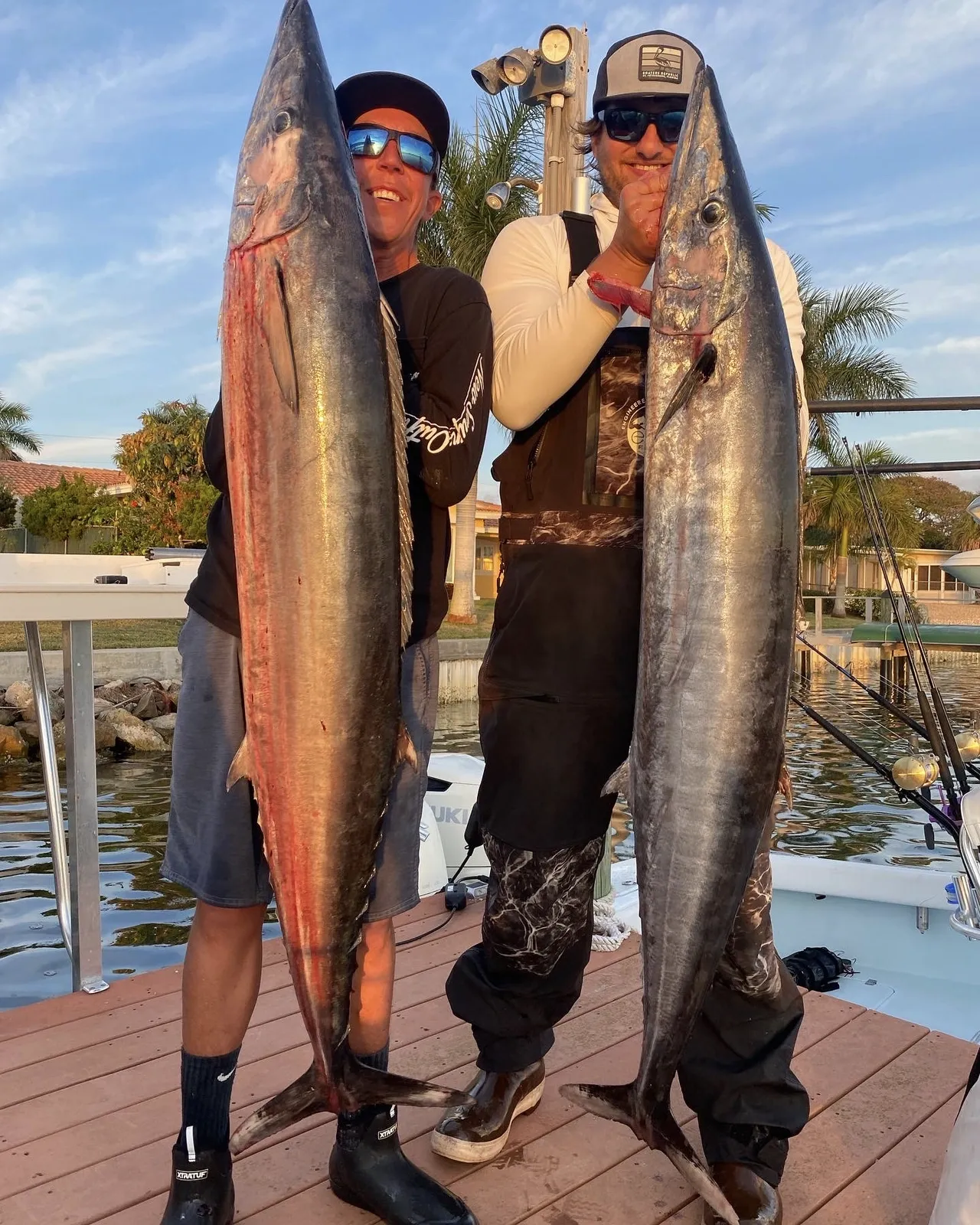 successful-fishing-charters-with-big-catch-on-dock-at-sunset