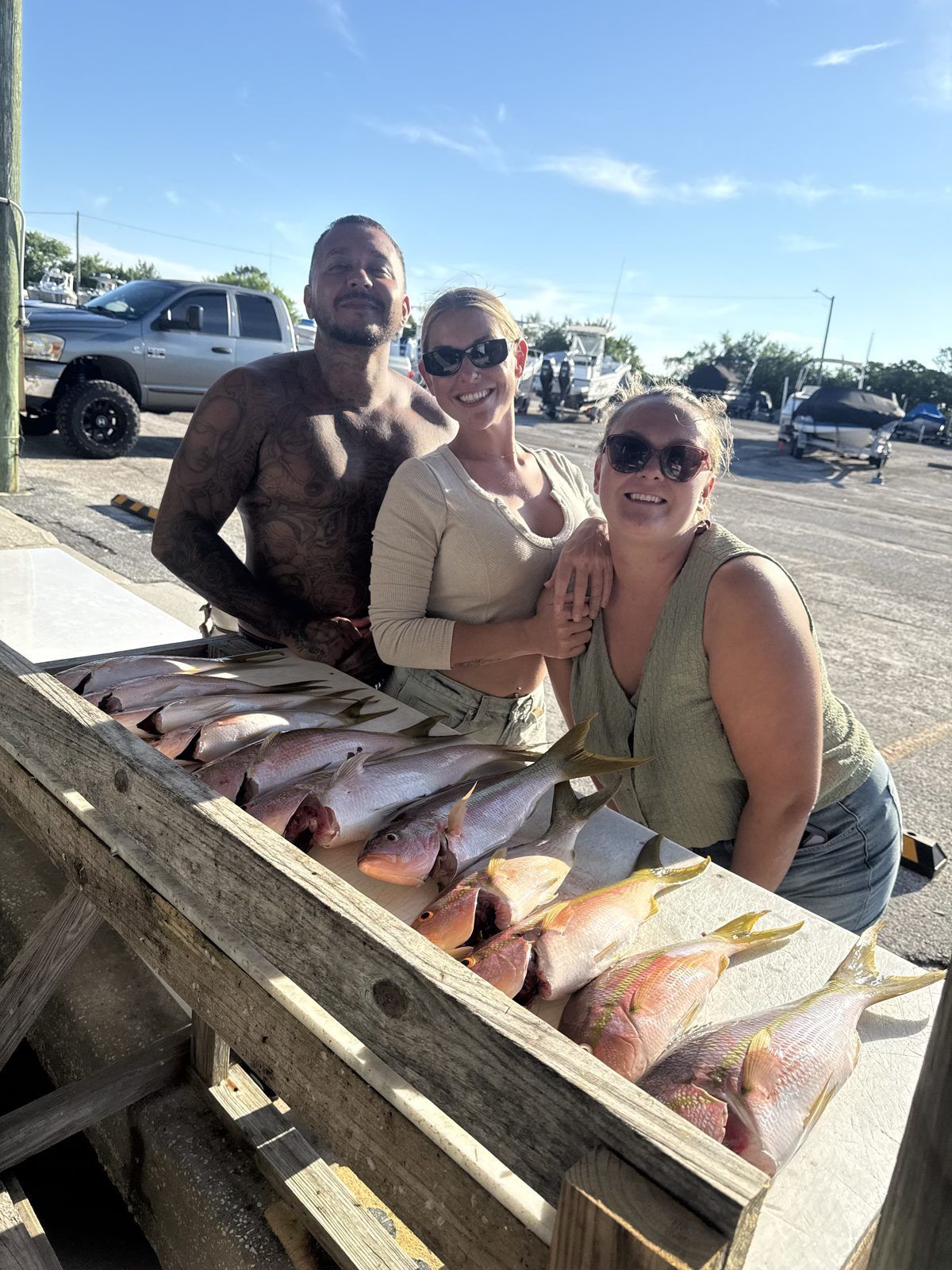 Group at the dock with their yellowtail snapper haul after a St. Petersburg fishing charter