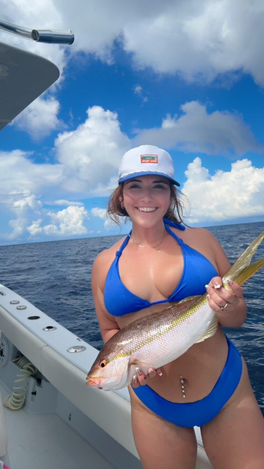 Guest with a yellowtail snapper on the Inverted Fishing Charters boat