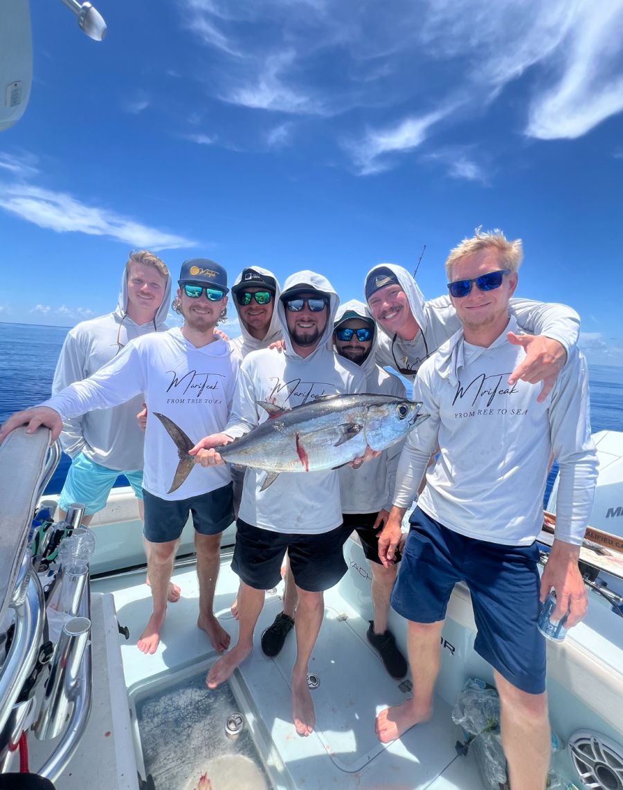 Team of anglers on the Inverted Fishing Charters boat holding their catch offshore of St. Petersburg